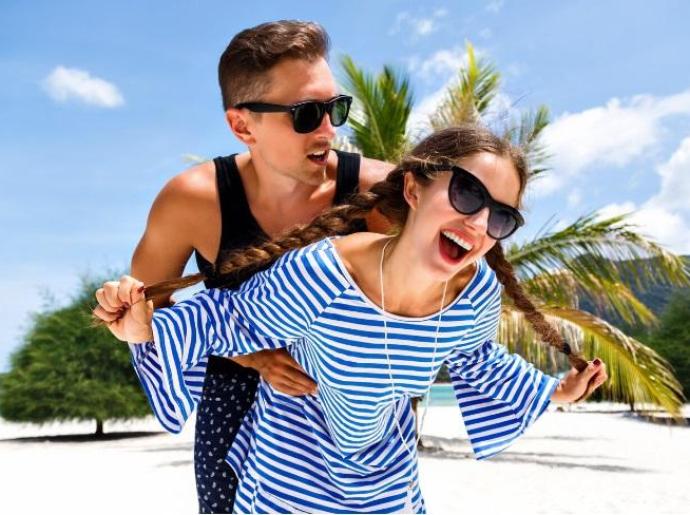 Happy couple on the beach, sun and fun.